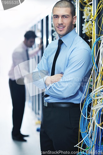 Image of it engineers in network server room