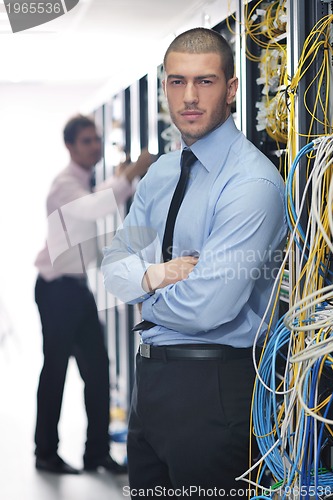 Image of it engineers in network server room