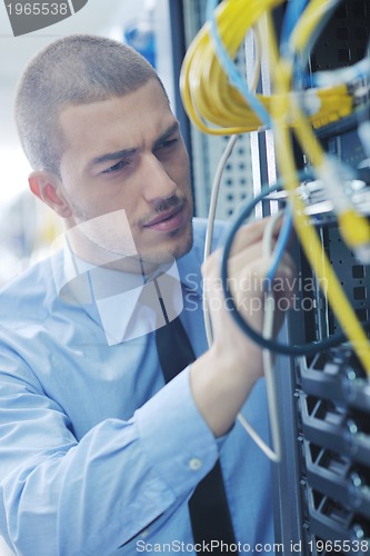 Image of young it engeneer in datacenter server room