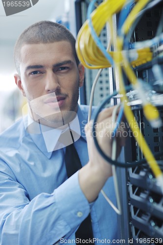 Image of young it engeneer in datacenter server room