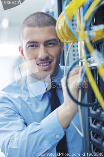 Image of young it engeneer in datacenter server room