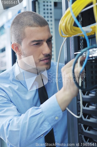 Image of young it engeneer in datacenter server room