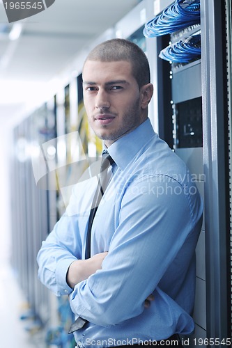 Image of young it engeneer in datacenter server room