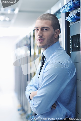 Image of young it engeneer in datacenter server room