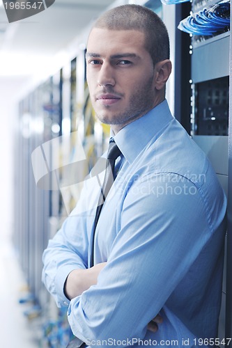 Image of young it engeneer in datacenter server room