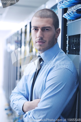 Image of young it engeneer in datacenter server room