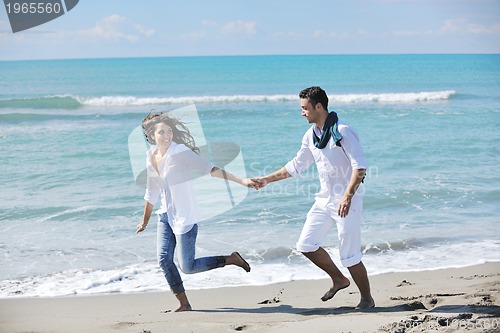 Image of happy young couple have fun at beautiful beach