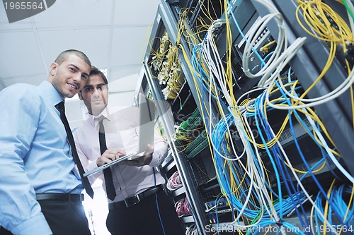 Image of it engineers in network server room