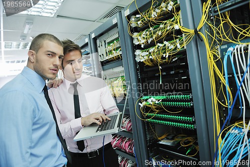 Image of it engineers in network server room