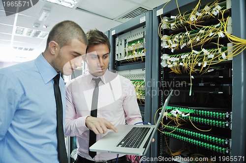 Image of it engineers in network server room