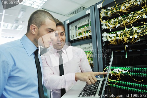 Image of it engineers in network server room