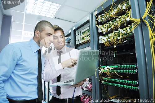 Image of it engineers in network server room