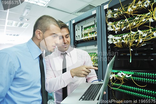 Image of it engineers in network server room