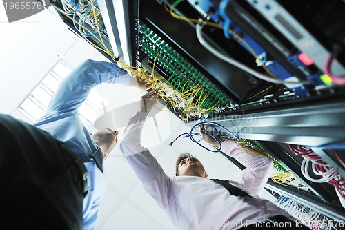 Image of it engineers in network server room