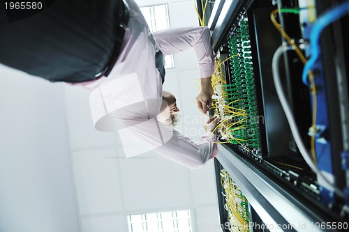 Image of young it engeneer in datacenter server room