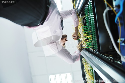 Image of young it engeneer in datacenter server room