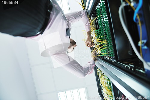 Image of young it engeneer in datacenter server room