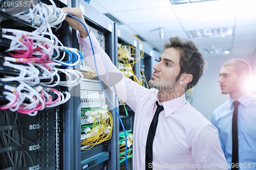 Image of it engineers in network server room