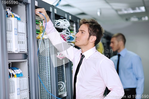 Image of it engineers in network server room