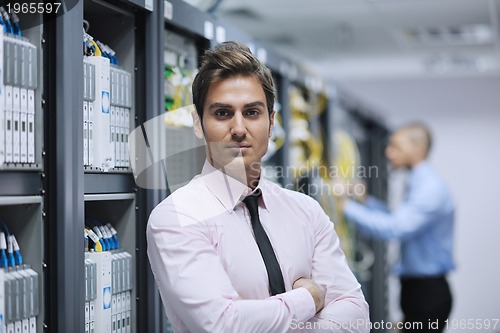 Image of it engineers in network server room