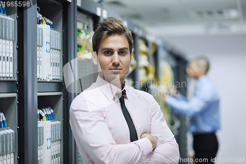 Image of it engineers in network server room