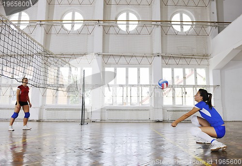 Image of girls playing volleyball indoor game