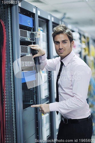 Image of young it engineer in datacenter server room