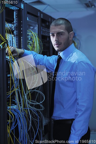 Image of young it engineer in datacenter server room