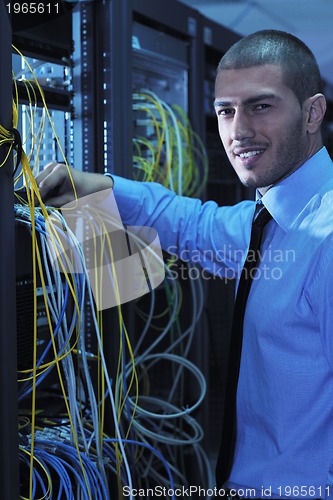 Image of young it engineer in datacenter server room