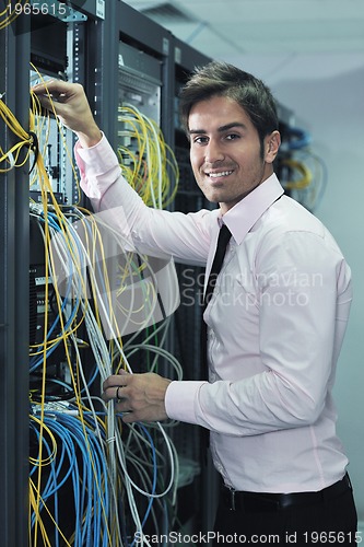 Image of young it engineer in datacenter server room