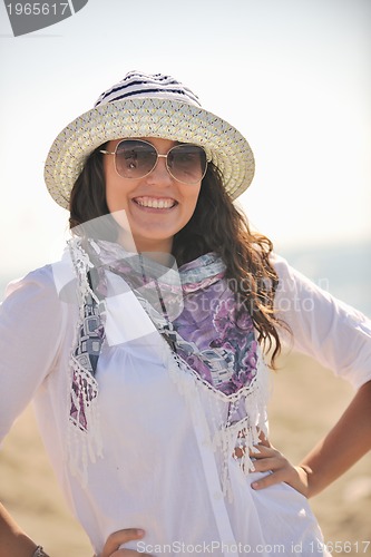 Image of happy young woman on beach