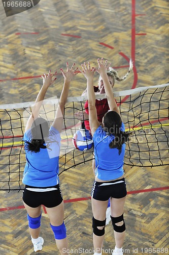 Image of girls playing volleyball indoor game