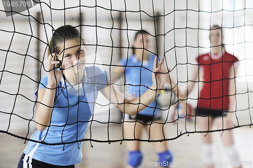 Image of girls playing volleyball indoor game