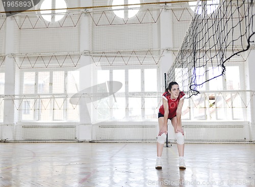 Image of girls playing volleyball indoor game