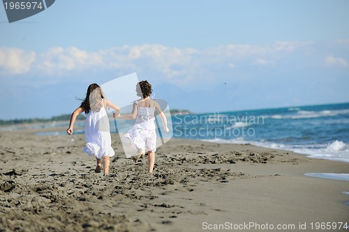 Image of cute little girls running on beach