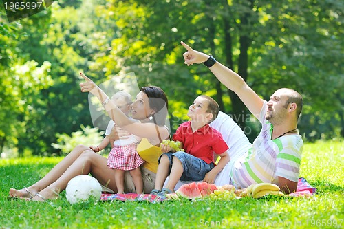 Image of happy young couple with their children have fun at park