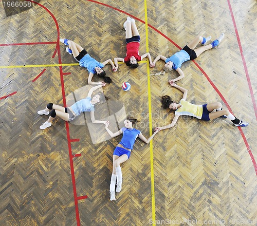 Image of girls playing volleyball indoor game