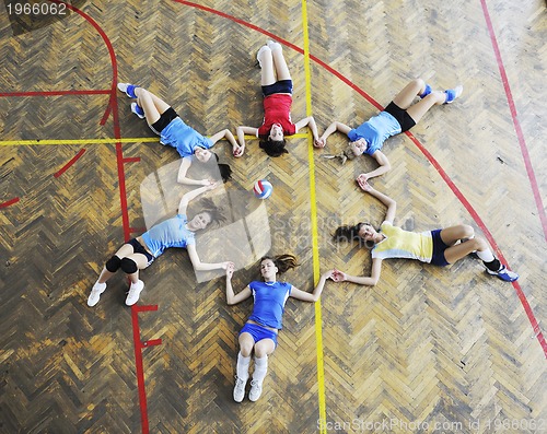 Image of girls playing volleyball indoor game