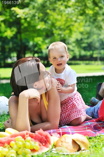 Image of woman and baby playing at park