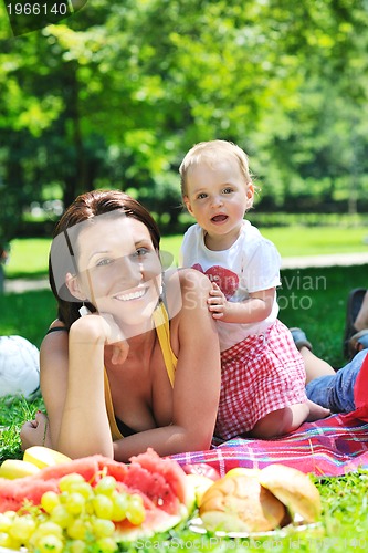 Image of woman and baby playing at park