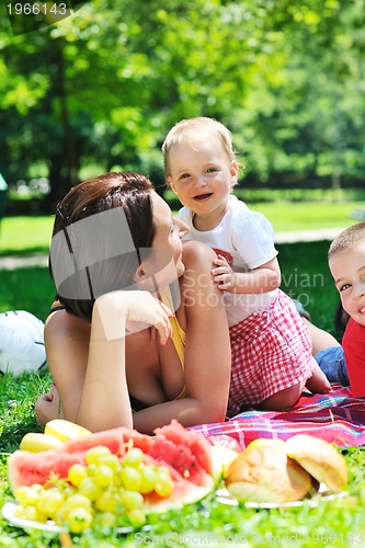 Image of woman and baby playing at park