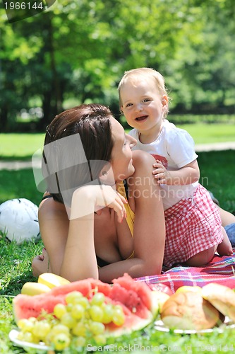 Image of woman and baby playing at park