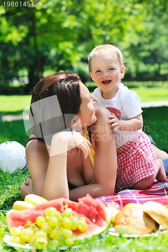 Image of woman and baby playing at park