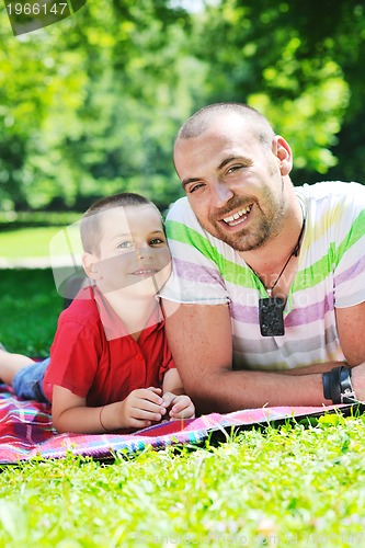 Image of happy father and son have fun at park