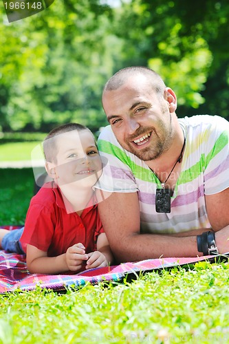 Image of happy father and son have fun at park