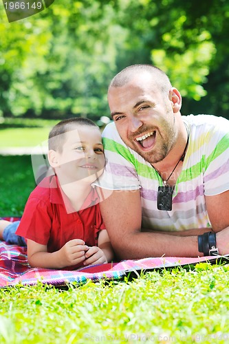 Image of happy father and son have fun at park