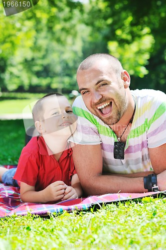 Image of happy father and son have fun at park