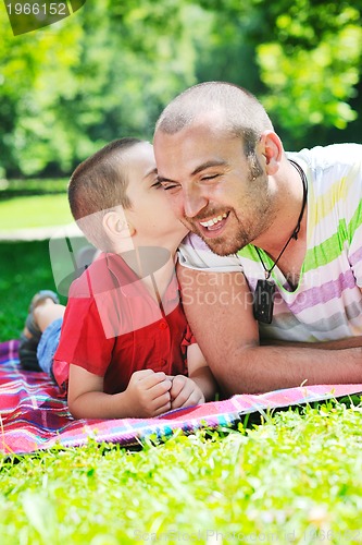 Image of happy father and son have fun at park