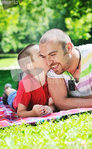 Image of happy father and son have fun at park