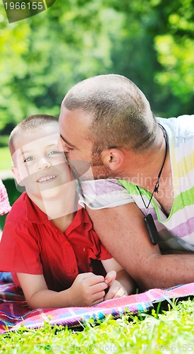 Image of happy father and son have fun at park